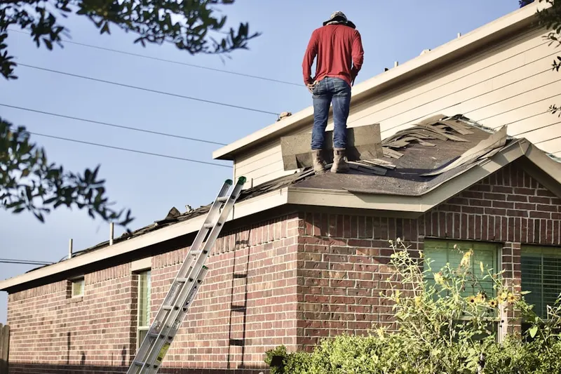 Professional roofer working on a residential roof in Prairie View